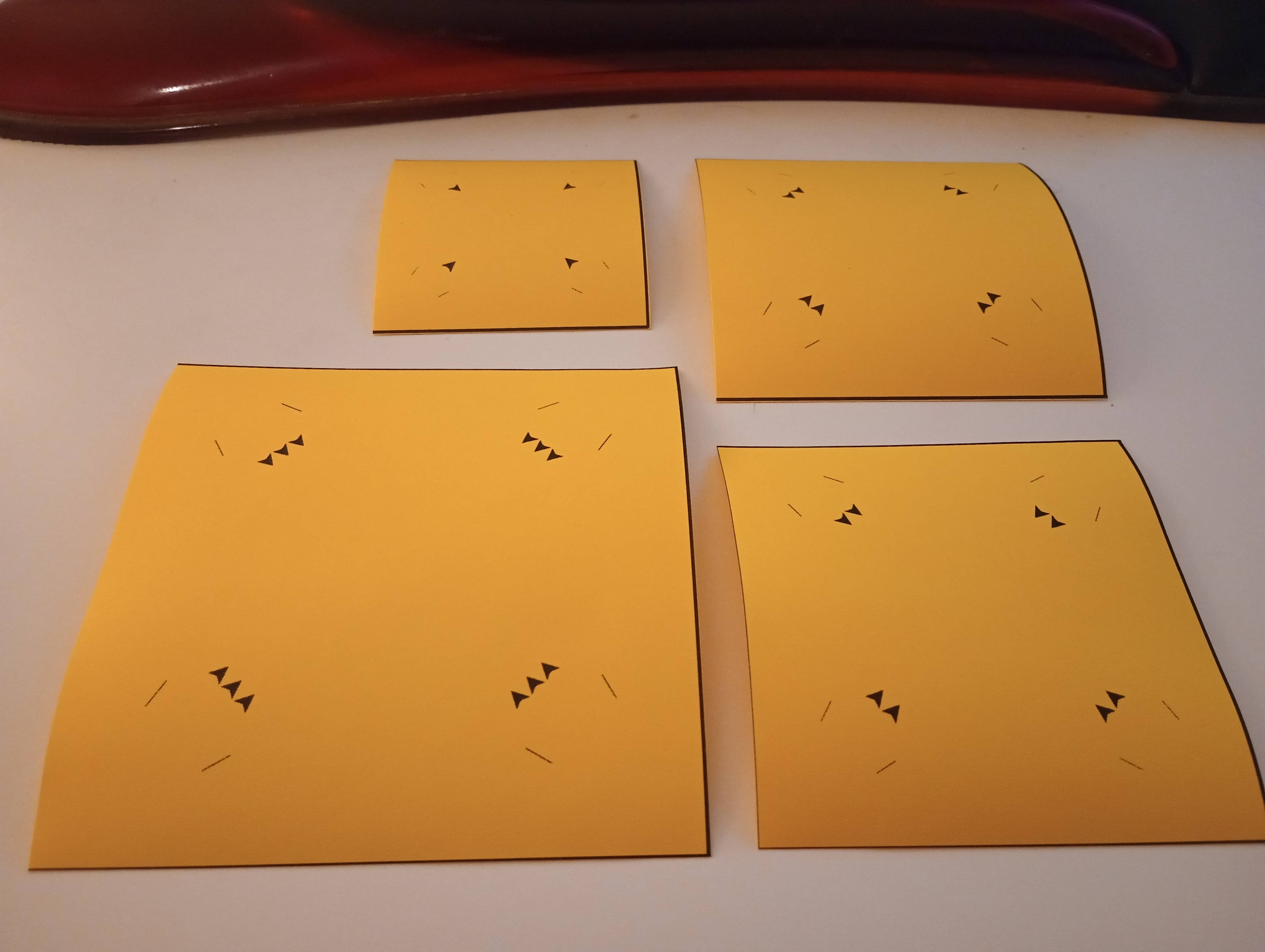 four paper squares on a table